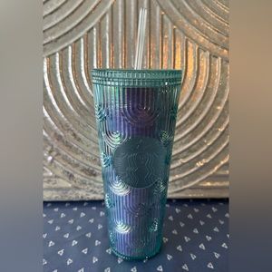 Starbucks tumbler with straw.